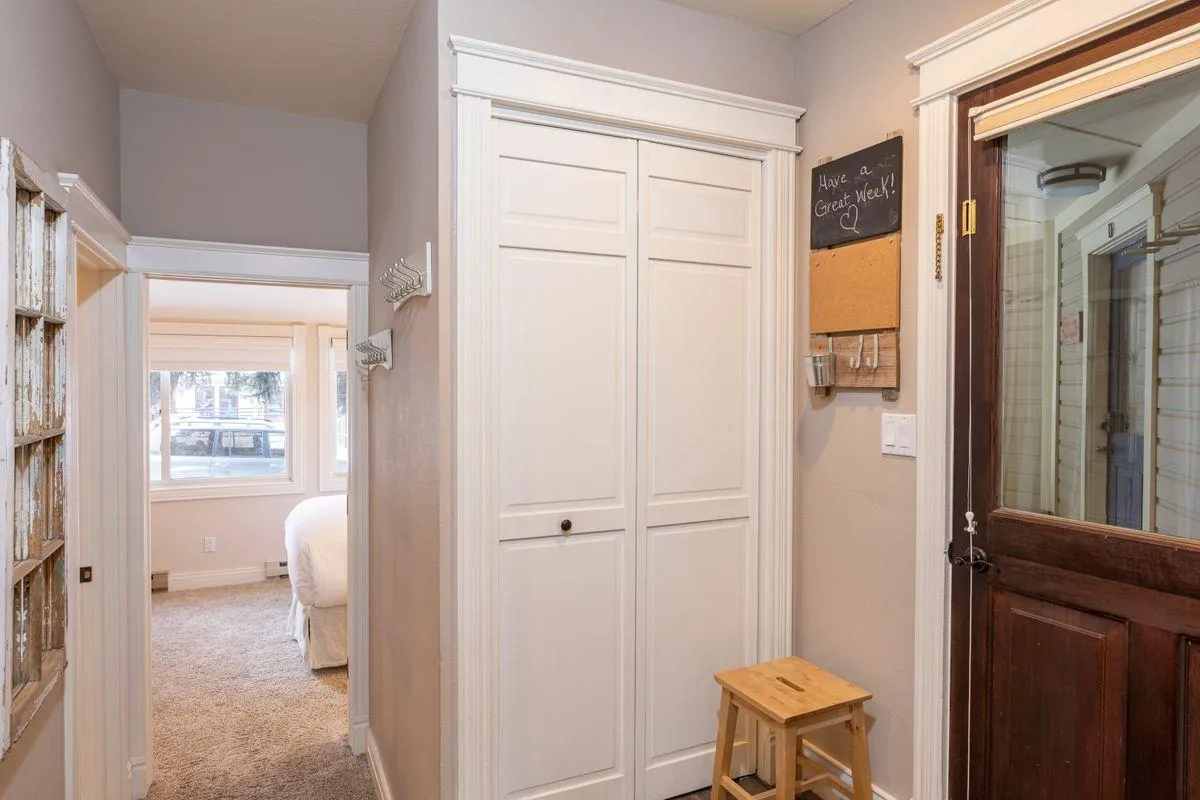 A welcoming mudroom with closet space, a stool, and a chalkboard greets you at the entryway. This tidy, practical space is ideal for shedding boots, coats, and outdoor gear, setting the tone for privacy and comfort right from the start.